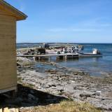 AroundNL-33 Harbors are scarce on the west coast of the Northern Penninsula, some no more than haulouts. This one has a pier and a natural breakwater.