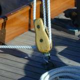 mysb1 Detail of a yacht. A fiddle block with tiller comb in background.